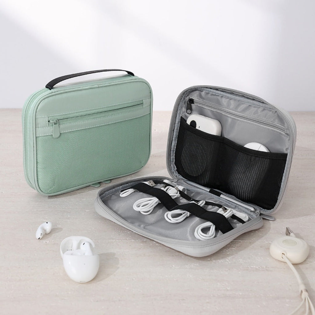 Mint-green travel accessory pouch beside an open gray case holding cords, chargers and earphones.