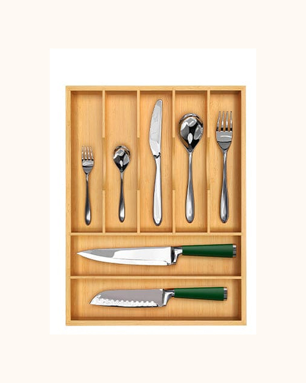 Natural bamboo seven-compartment silverware organizer with flatware and kitchen knives on a warm ivory background.