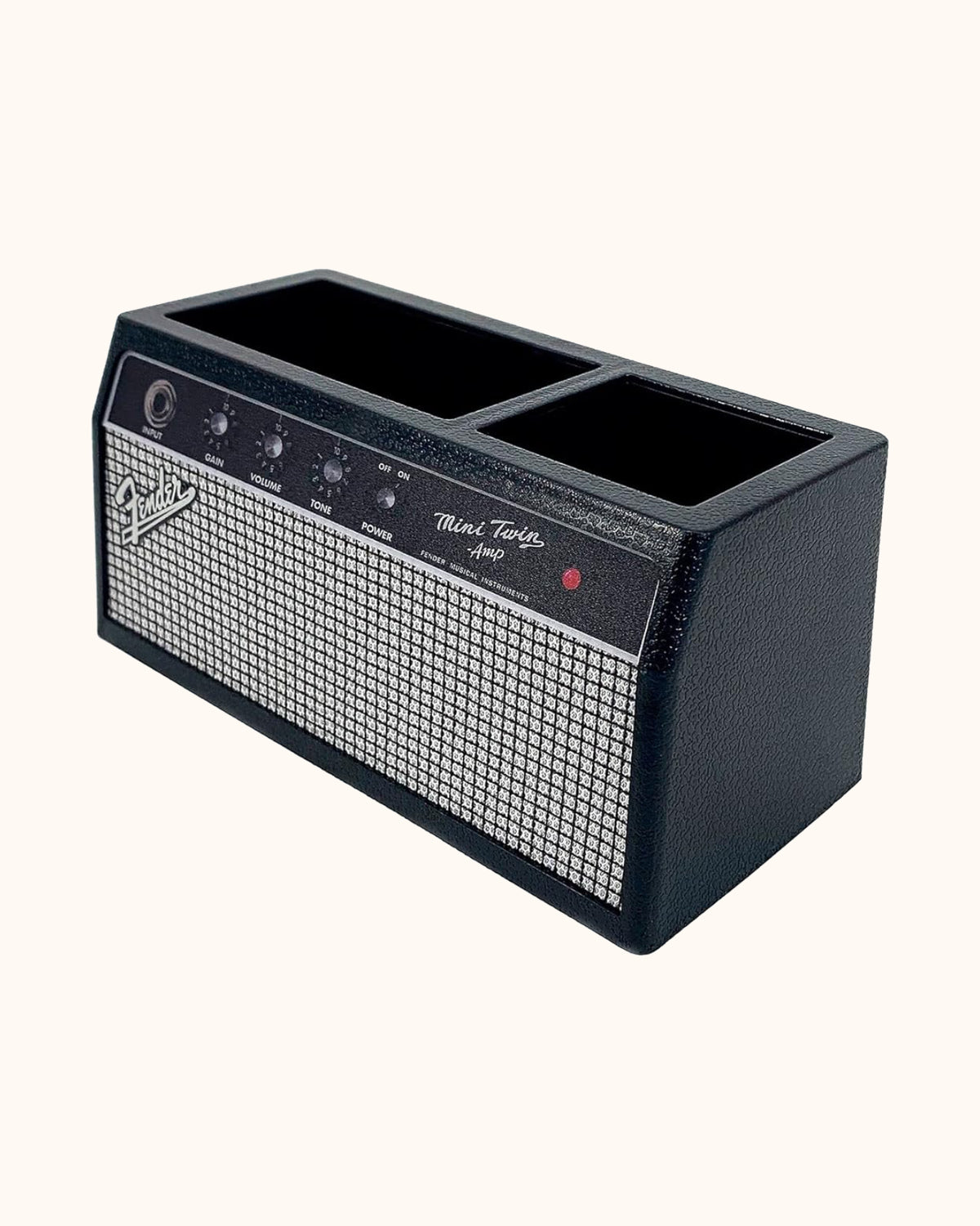 Black Fender amplifier-style desk organizer on a warm ivory background.