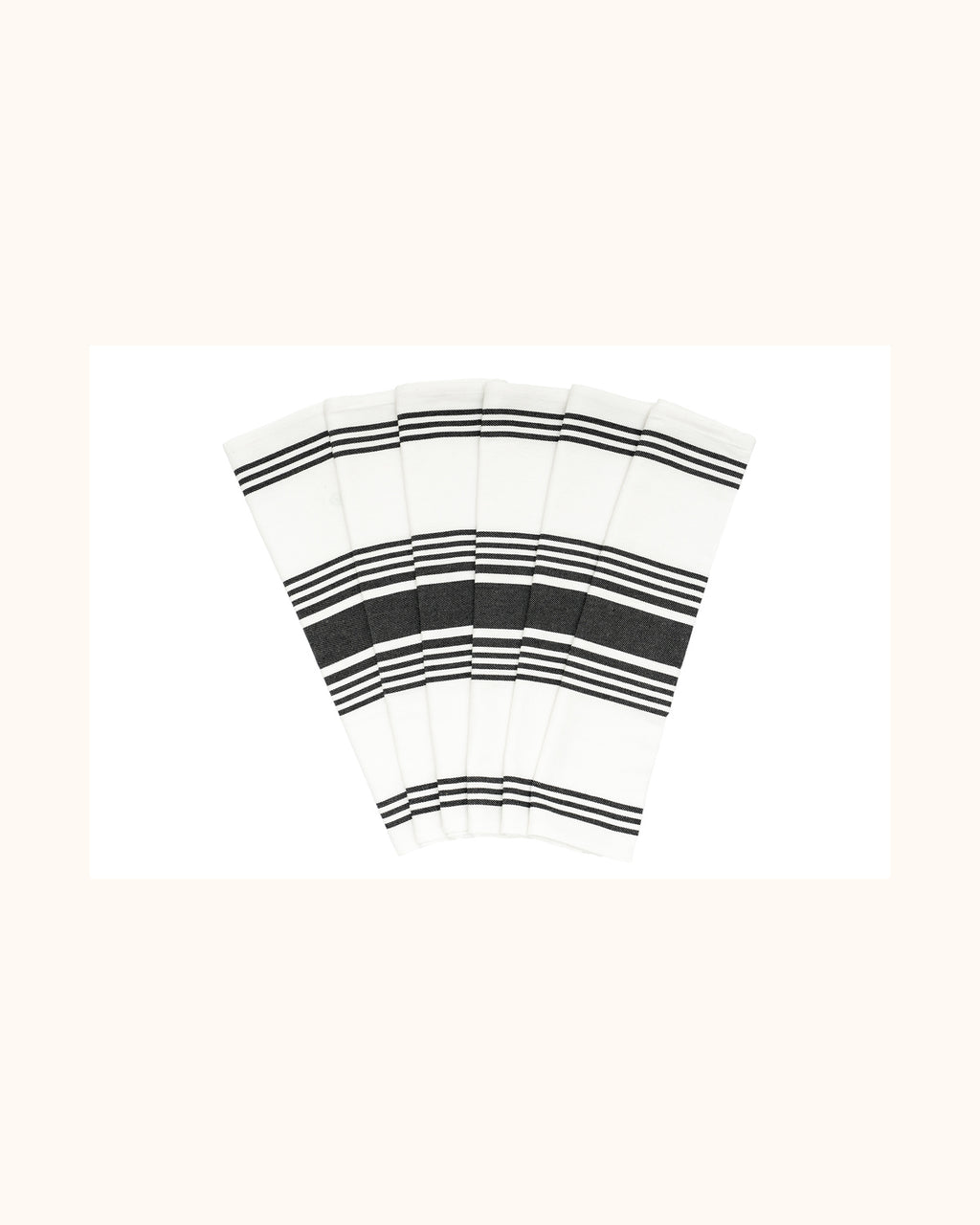 Six white striped cotton kitchen towels arranged in a fan on a warm ivory background.